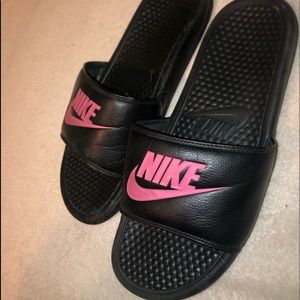 pink and black nike slides.